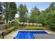 Overhead view of a large backyard swimming pool with lush landscaping and partial fence at 630 Dana Pointe Ct, Lawrenceville, GA 30045