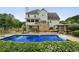 Backyard with a large inground pool, surrounding patio, gazebo and lush landscaping at 630 Dana Pointe Ct, Lawrenceville, GA 30045