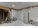 Unfinished basement with a bike, storage cabinet, and exposed ductwork offers potential for customization and added living space at 1258 Rocky Branch Trl, Lawrenceville, GA 30043