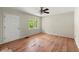 Bedroom with wood floors, a ceiling fan, and a bright window, making it the perfect retreat to unwind at 129 Bill Smith Dr, Canton, GA 30114