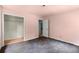 Bedroom featuring pale pink walls, neutral carpet and a door to a walk-in closet at 129 Bill Smith Dr, Canton, GA 30114