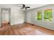 Bedroom featuring hardwood floors, ceiling fan, and a large window, creating a bright and airy atmosphere at 129 Bill Smith Dr, Canton, GA 30114