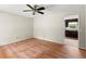 Bedroom with hard wood floors, ceiling fan, and view of the kitchen, creating a cozy and inviting space at 129 Bill Smith Dr, Canton, GA 30114