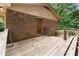 Exterior wooden deck leading to brick home's entrance, rustic charm and outdoor living space at 129 Bill Smith Dr, Canton, GA 30114