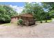 Charming brick home featuring a wooden deck surrounded by lush greenery and a spacious yard at 129 Bill Smith Dr, Canton, GA 30114
