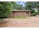 Rear view of a brick home surrounded by a yard; showcasing windows and utility access at 129 Bill Smith Dr, Canton, GA 30114