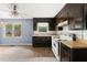 Vintage kitchen featuring dark cabinetry, butcher block countertops, and white appliances. Natural light fills the space at 129 Bill Smith Dr, Canton, GA 30114