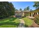Expansive backyard with lush landscaping, a stone pathway, and views of the grand brick home at 2883 Andrews Nw Dr, Atlanta, GA 30305