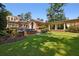 Picturesque backyard featuring lush lawn, manicured garden beds, and colonnade at 2883 Andrews Nw Dr, Atlanta, GA 30305