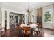 Elegant dining room with modern light fixture, hardwood floors, and large windows at 2883 Andrews Nw Dr, Atlanta, GA 30305