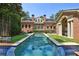 Backyard with large rectangular pool and views of the expansive brick home at 2883 Andrews Nw Dr, Atlanta, GA 30305