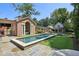 Backyard pool with stone patio, landscaped yard, and pool house at 2883 Andrews Nw Dr, Atlanta, GA 30305