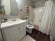 Bathroom featuring a vanity sink, arched mirror, pink towels, and shower with curtain at 3915 Woodridge Way, Tucker, GA 30084