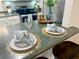Close-up of a well-staged breakfast bar with elegant place settings and decor at 3915 Woodridge Way, Tucker, GA 30084