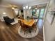 Open concept dining room with a wooden table, chandelier, and view into the living room at 3915 Woodridge Way, Tucker, GA 30084
