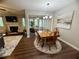 Open dining and living area with a fireplace, vintage table, and a view to a home office at 3915 Woodridge Way, Tucker, GA 30084