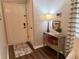 Well-lit foyer features hardwood floors, neutral walls, stylish console table with decor, and front door at 3915 Woodridge Way, Tucker, GA 30084