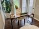 Bright home office featuring a modern desk, comfortable chair, and lush potted plant at 3915 Woodridge Way, Tucker, GA 30084