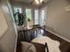 Sunny home office with large windows, a wood desk, fur rug and stylish decor at 3915 Woodridge Way, Tucker, GA 30084