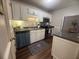 Functional kitchen with modern stainless steel appliances, white cabinets, and dark countertops at 3915 Woodridge Way, Tucker, GA 30084