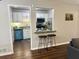 Open concept kitchen with breakfast bar featuring seating and stylish accents at 3915 Woodridge Way, Tucker, GA 30084