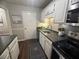 Updated kitchen features white cabinets and modern appliances with hardwood flooring at 3915 Woodridge Way, Tucker, GA 30084