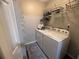 A convenient laundry room featuring a washer and dryer with storage shelves for organization at 3915 Woodridge Way, Tucker, GA 30084