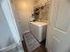 A convenient laundry room featuring a washer and dryer with storage shelves for organization at 3915 Woodridge Way, Tucker, GA 30084