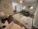 Bright living room showcases hardwood floors, neutral walls, stylish furnishings, and a view into dining area at 3915 Woodridge Way, Tucker, GA 30084