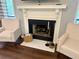 Cozy living room featuring a fireplace with a white mantel and two comfortable armchairs at 3915 Woodridge Way, Tucker, GA 30084