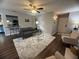 Cozy living room featuring hardwood floors, neutral decor, a view into kitchen bar, and lots of sunlight at 3915 Woodridge Way, Tucker, GA 30084