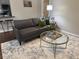Stylish living room with hardwood floors, neutral colors, a round glass coffee table, and modern furnishings at 3915 Woodridge Way, Tucker, GA 30084