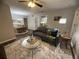Comfortable living room with hardwood floors, neutral decor, ceiling fan, and view into adjacent dining area at 3915 Woodridge Way, Tucker, GA 30084