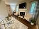 Bright living room with hardwood floors, neutral walls, modern furnishings, fireplace, and lots of natural light at 3915 Woodridge Way, Tucker, GA 30084