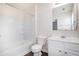 This bathroom features a white vanity, toilet, and a shower-tub combo with tile surround at 931 Society Cir, Atlanta, GA 30331