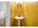 Bright half bathroom with pedestal sink and yellow wall at 931 Society Cir, Atlanta, GA 30331