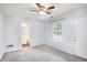 Bedroom featuring a ceiling fan, carpeted floors, and a window with backyard views at 931 Society Cir, Atlanta, GA 30331