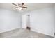 Bedroom with plush carpet and ceiling fan showing doorway to bathroom at 931 Society Cir, Atlanta, GA 30331