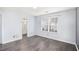 Bedroom with gray laminate floors, a window, and ensuite bathroom at 931 Society Cir, Atlanta, GA 30331