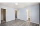 Bright bedroom with wood-look floors, multiple doorways, and ample closet space for storage at 931 Society Cir, Atlanta, GA 30331
