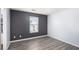 This bedroom features stylish gray wood-look flooring and a window that provides natural light at 931 Society Cir, Atlanta, GA 30331
