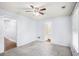 Bright bedroom with neutral walls, plush carpeting, ceiling fan, and easy access to the bathroom at 931 Society Cir, Atlanta, GA 30331