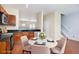 Eat-in kitchen with warm wood cabinets, granite countertops, stainless appliances, and a nearby staircase at 931 Society Cir, Atlanta, GA 30331
