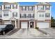 Attractive townhome with neutral siding, dark shutters, brick accents, a single-car garage, and concrete driveway at 931 Society Cir, Atlanta, GA 30331