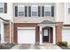 Close-up of the townhome showing the brick accents, single-car garage, and covered front entrance at 931 Society Cir, Atlanta, GA 30331