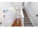 Hallway with hardwood floors, gray walls, and a staircase with gray carpet at 931 Society Cir, Atlanta, GA 30331