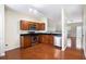 Open kitchen with modern appliances, wood cabinets, and hardwood flooring at 931 Society Cir, Atlanta, GA 30331