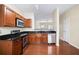 Well-lit kitchen with stainless steel appliances and black granite countertops at 931 Society Cir, Atlanta, GA 30331