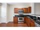 Kitchen featuring modern stainless steel appliances, wood cabinets, and black countertop at 931 Society Cir, Atlanta, GA 30331