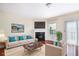 Bright living room with hardwood floors, fireplace, recessed lighting, and large windows for natural light at 931 Society Cir, Atlanta, GA 30331